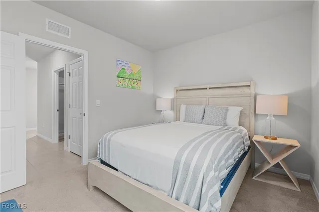 a bedroom with a bed and a lamp