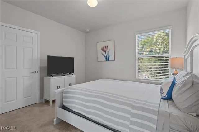 a bedroom with a bed and a television