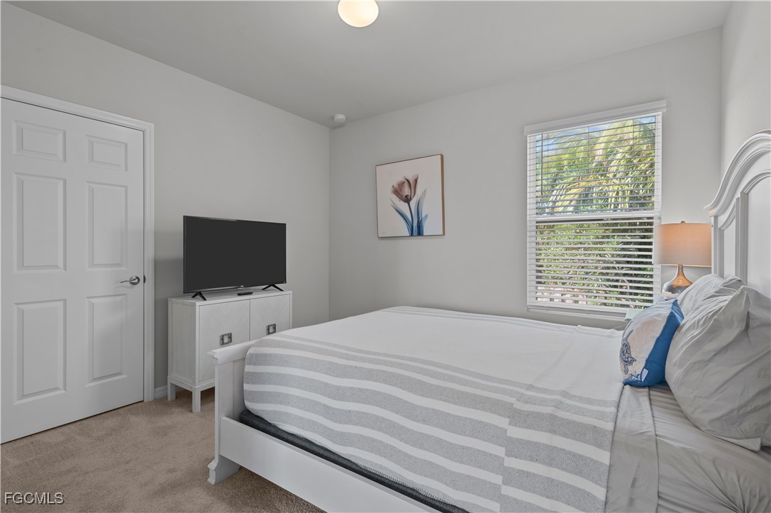 4320 Little Hickory Road Bonita Springs, FL 34134 - Photo 25 of 27 a bedroom with a bed and a television