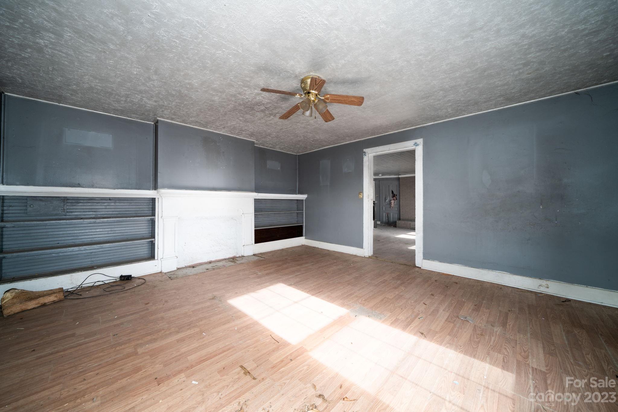 596 Old Mooresboro Road Mooresboro, NC 28114 - Photo 12 of 40 a view of a livingroom with a chandelier fan and windows
