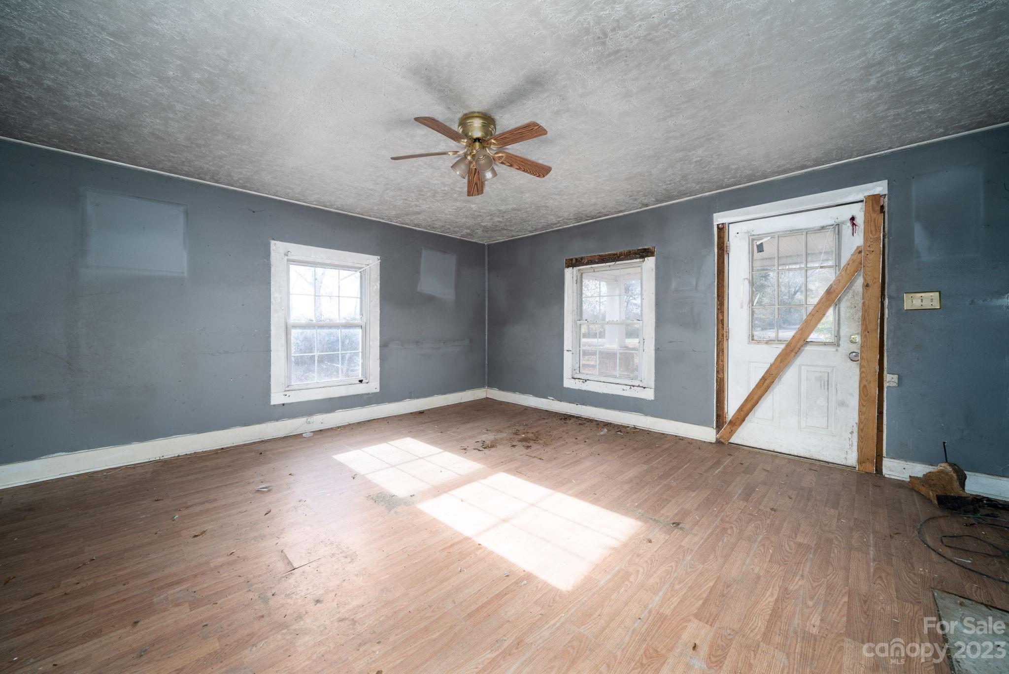 596 Old Mooresboro Road Mooresboro, NC 28114 - Photo 13 of 40 a view of an empty room with wooden floor and a window