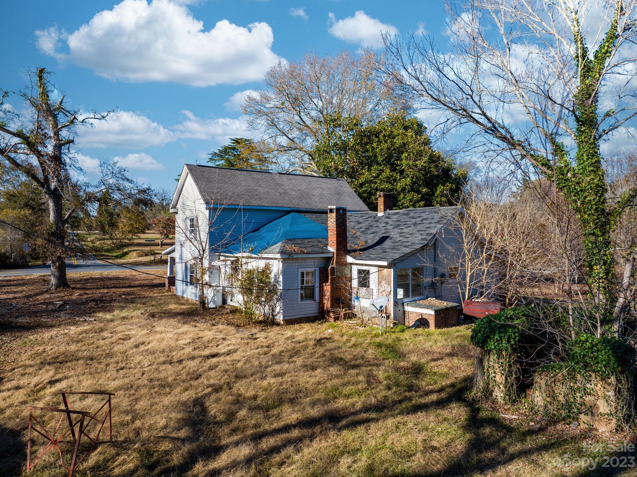 596 Old Mooresboro Road Mooresboro, NC 28114 - Photo 26 of 40 a view of a house with a large tree and a yard