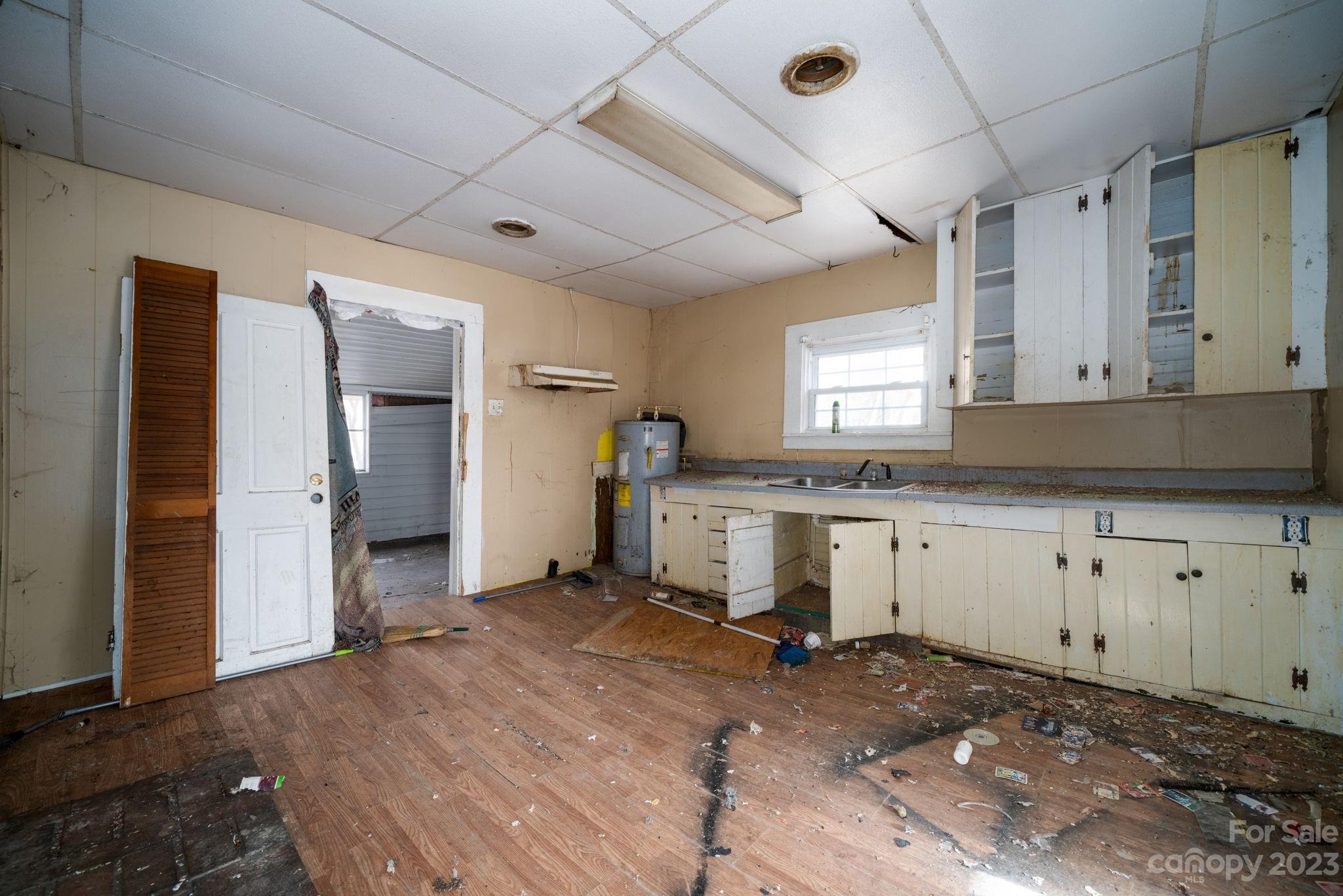 596 Old Mooresboro Road Mooresboro, NC 28114 - Photo 6 of 40 a view of a kitchen with refrigerator and microwave