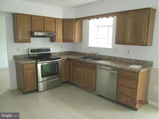 426 Rachaels Way Prince Frederick, MD 20678 - Photo 3 of 22 a kitchen with granite countertop a sink stove and cabinets