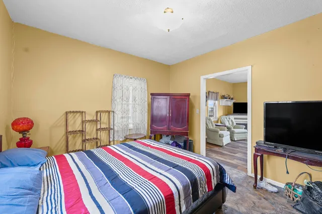 a bedroom with a bed and a flat screen tv