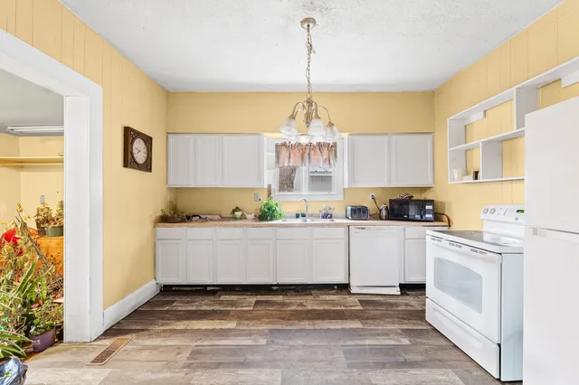 a kitchen with a stove a sink and cabinets