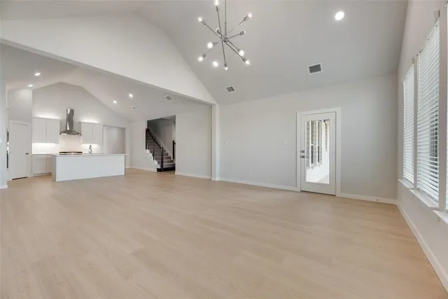 a view of a livingroom with a kitchen and a window