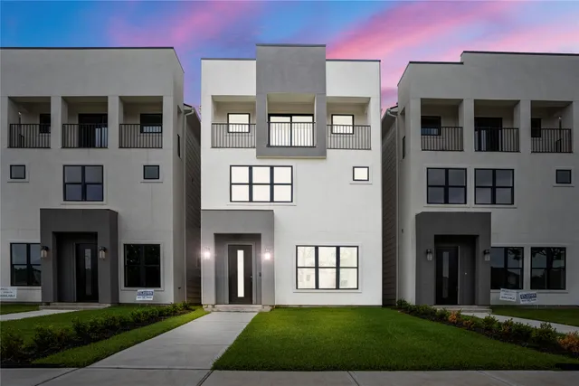 a front view of a residential apartment building with a yard