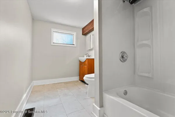 a bathroom with a bathtub and shower