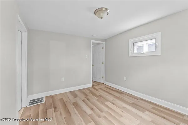 a view of room with wooden floor and fan