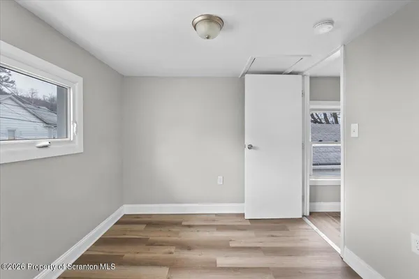 a view of an empty room with a window