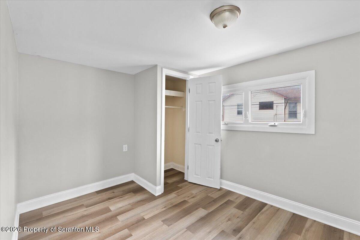 18 Linden Street Luzerne, PA 18709 - Photo 23 of 32 an empty room with wooden floor and windows