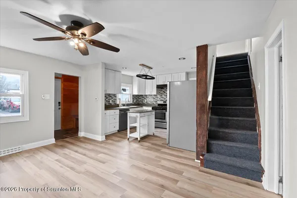 a view of kitchen with sink and refrigerator