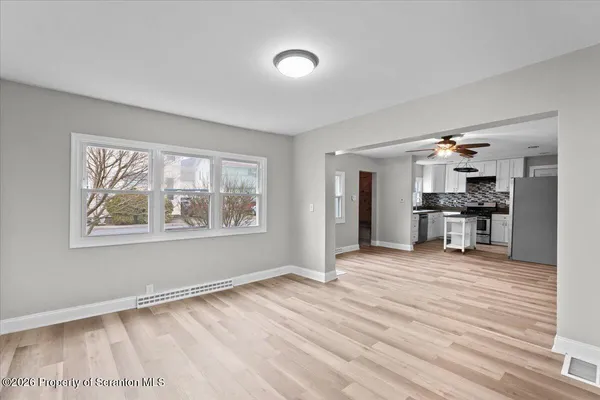 a view of a kitchen with a sink and cabinets