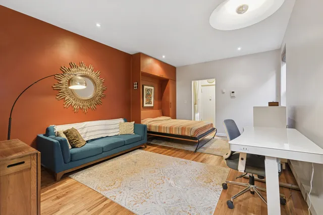 a living room with furniture and a dresser