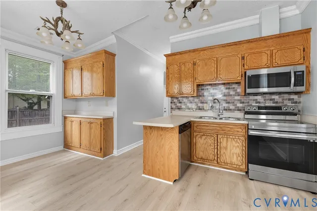 a kitchen with stainless steel appliances granite countertop a refrigerator a sink dishwasher a stove with wooden cabinets and floor