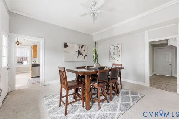 a dining room with furniture a chandelier and wooden floor