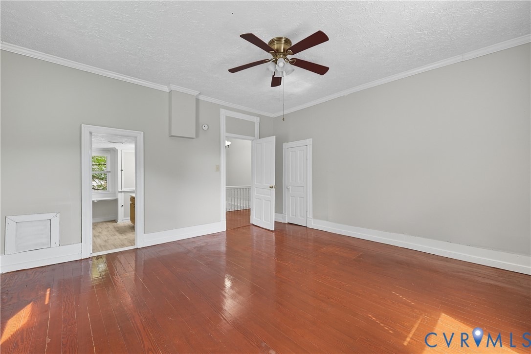 1022 South Main Street Blackstone, VA 23824 - Photo 25 of 35 an empty room with wooden floor and windows