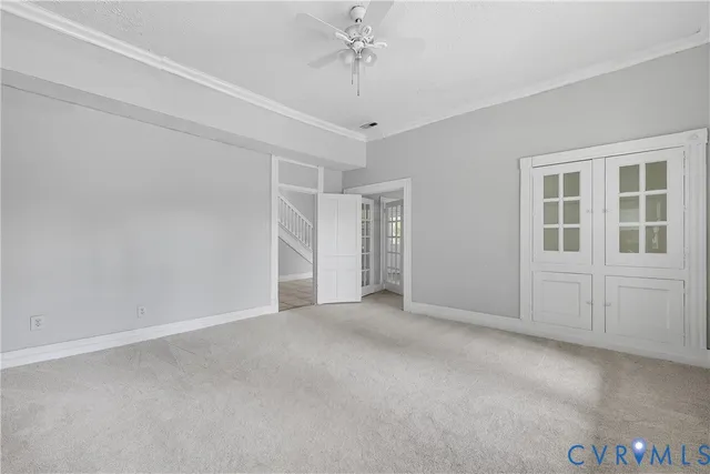 an empty room with windows and closet