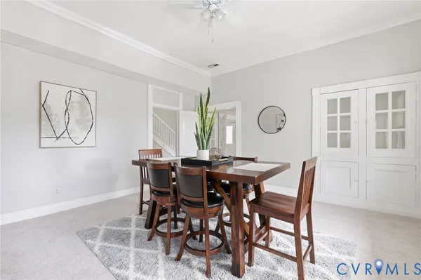 a kitchen with stainless steel appliances granite countertop a stove top oven a sink dishwasher a microwave oven and a dining table with wooden floor