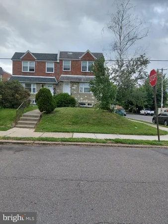 a front view of a house with a yard and a garage