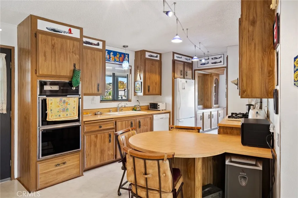 334 Bobwhite Paso Robles, CA 93446 - Photo 7 of 23 a kitchen with stainless steel appliances granite countertop a sink a stove and refrigerator