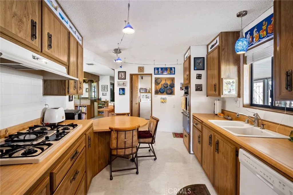 334 Bobwhite Paso Robles, CA 93446 - Photo 8 of 23 a kitchen that has a lot of cabinets a sink and a stove