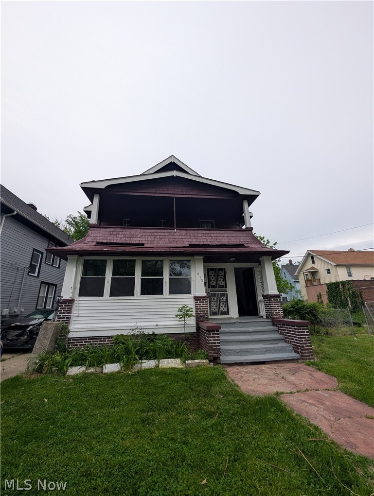 Two-story residence featuring a covered second-story balcony and a covered front porch