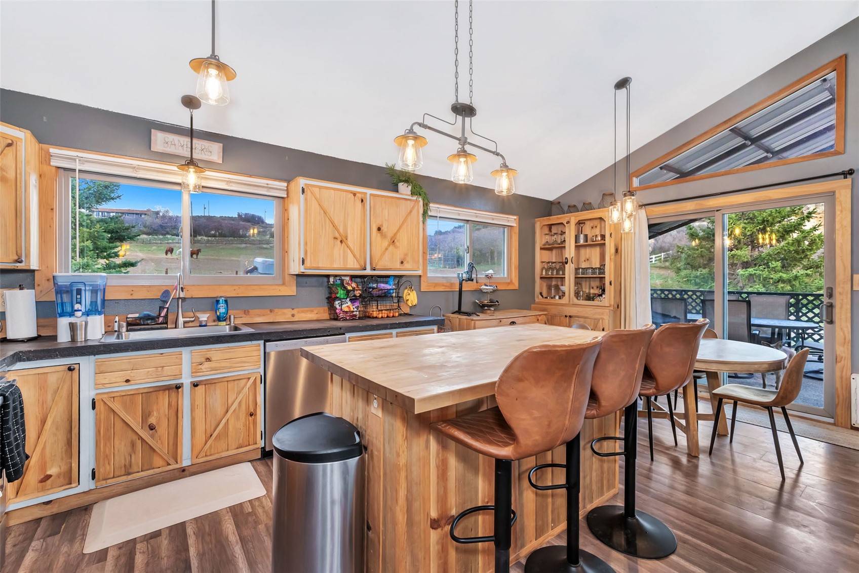 224 C R 206 Craig, CO 81625 - Photo 4 of 50 a kitchen with stainless steel appliances granite countertop a stove a refrigerator a kitchen island a dining table and chairs with wooden floor