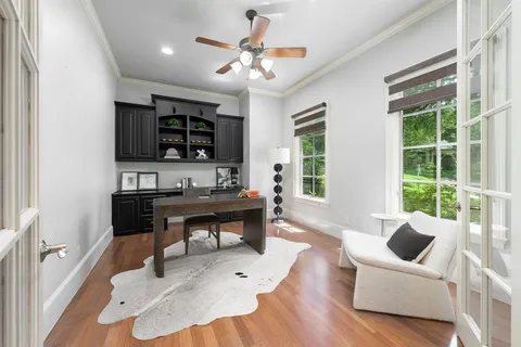a living room with furniture a flat screen tv and a large window