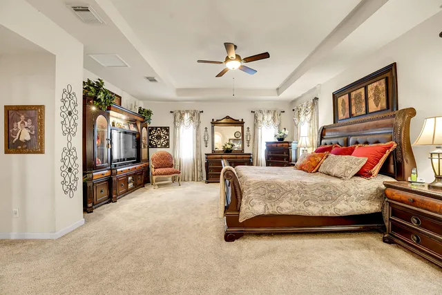 a bedroom with a bed and a chandelier