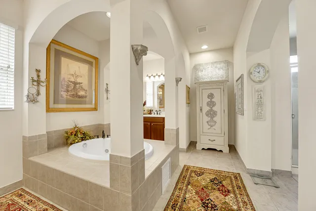 a bathroom with a granite countertop toilet sink and mirror