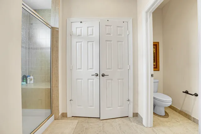 a bedroom with two beds and a flat screen tv