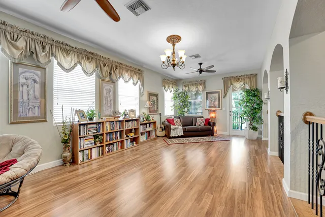 a view of a house with a big yard and large trees