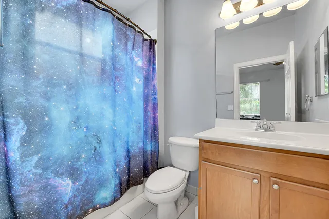 an aerial view of residential houses with outdoor space and trees