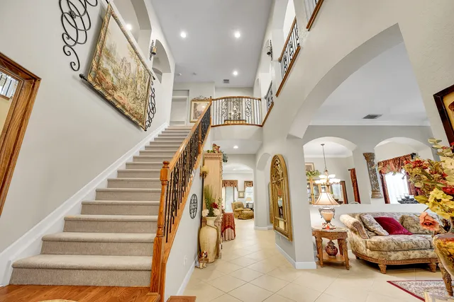 a living room with furniture and a large window with outer view