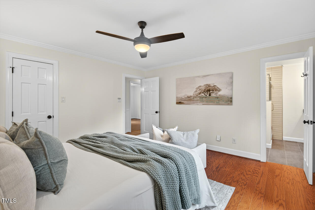 2805 Dunkirk Drive Raleigh, NC 27613 - Photo 17 of 36 a bedroom with a large bed and a ceiling fan