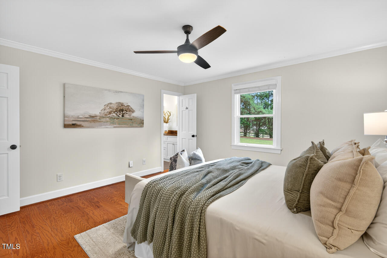 2805 Dunkirk Drive Raleigh, NC 27613 - Photo 18 of 36 a bedroom with a bed and a painting on the wall