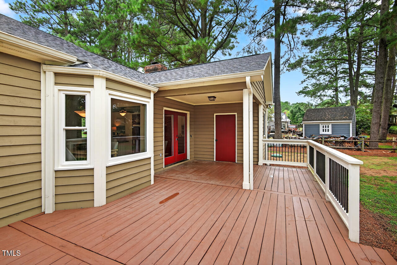 2805 Dunkirk Drive Raleigh, NC 27613 - Photo 28 of 36 a view of a house with a barbeque and wooden stairs