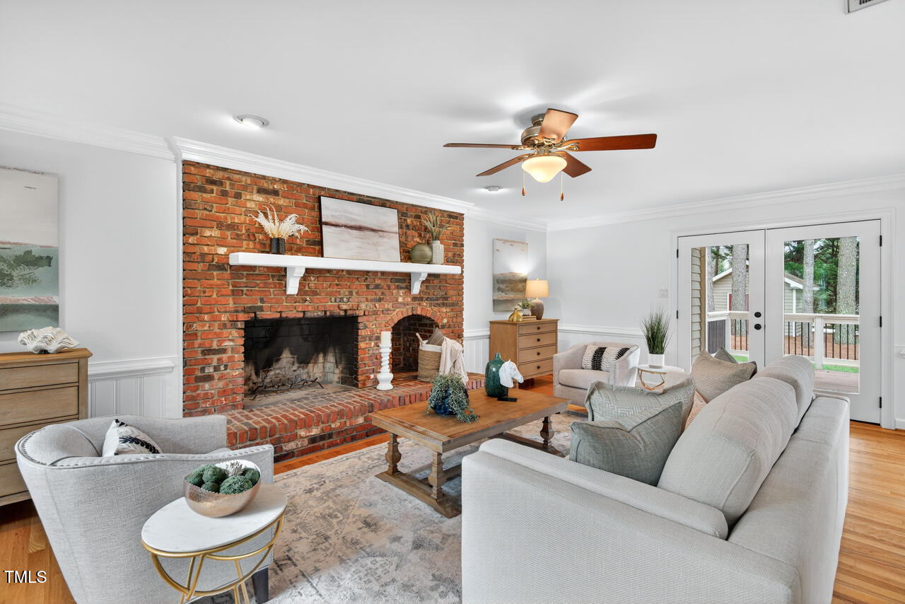 2805 Dunkirk Drive Raleigh, NC 27613 - Photo 7 of 36 a living room with furniture a fireplace and a large window