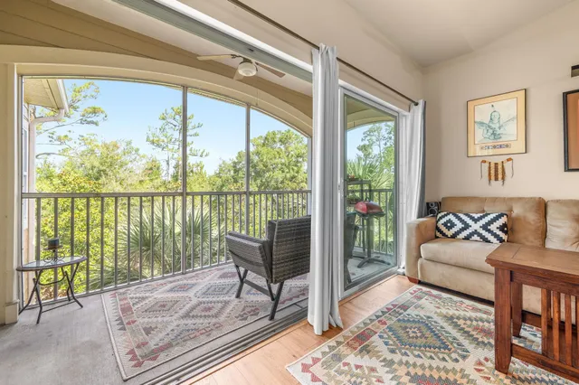a view of a bedroom with wooden floor and a potted plant