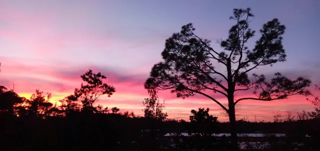 a spacious bathroom with a granite countertop sink a mirror and a bathtub
