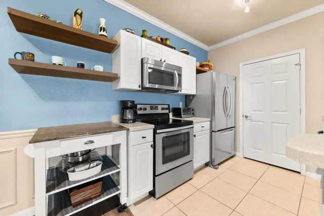 a bedroom with a bed a clock and a chandelier
