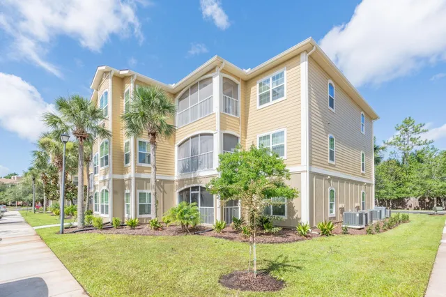a view of a swimming pool with a yard and sitting area