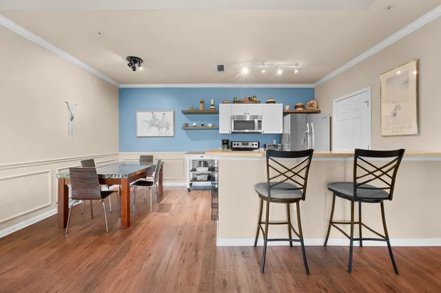 a view of a dining room with furniture and wooden floor