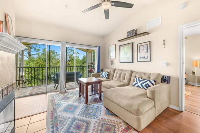 a living room with furniture a table and wooden floor
