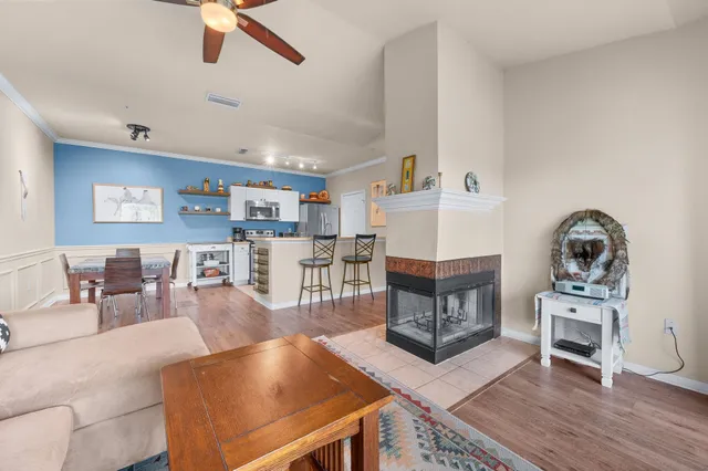a living room with furniture and a wooden floor