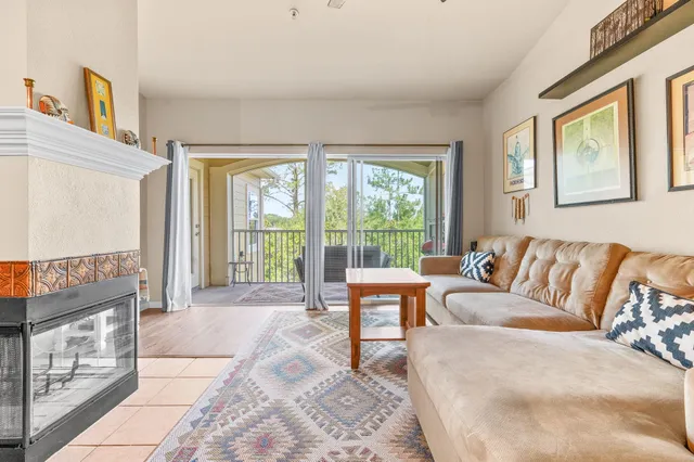 a living room with furniture and a floor to ceiling window