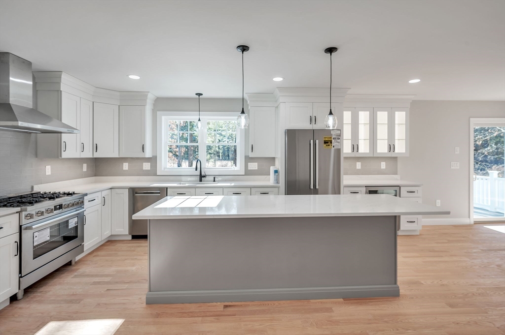 Lot B Georgianna Road Billerica, MA 01821 - Photo 8 of 32 a kitchen with stainless steel appliances granite countertop a sink a stove and a refrigerator