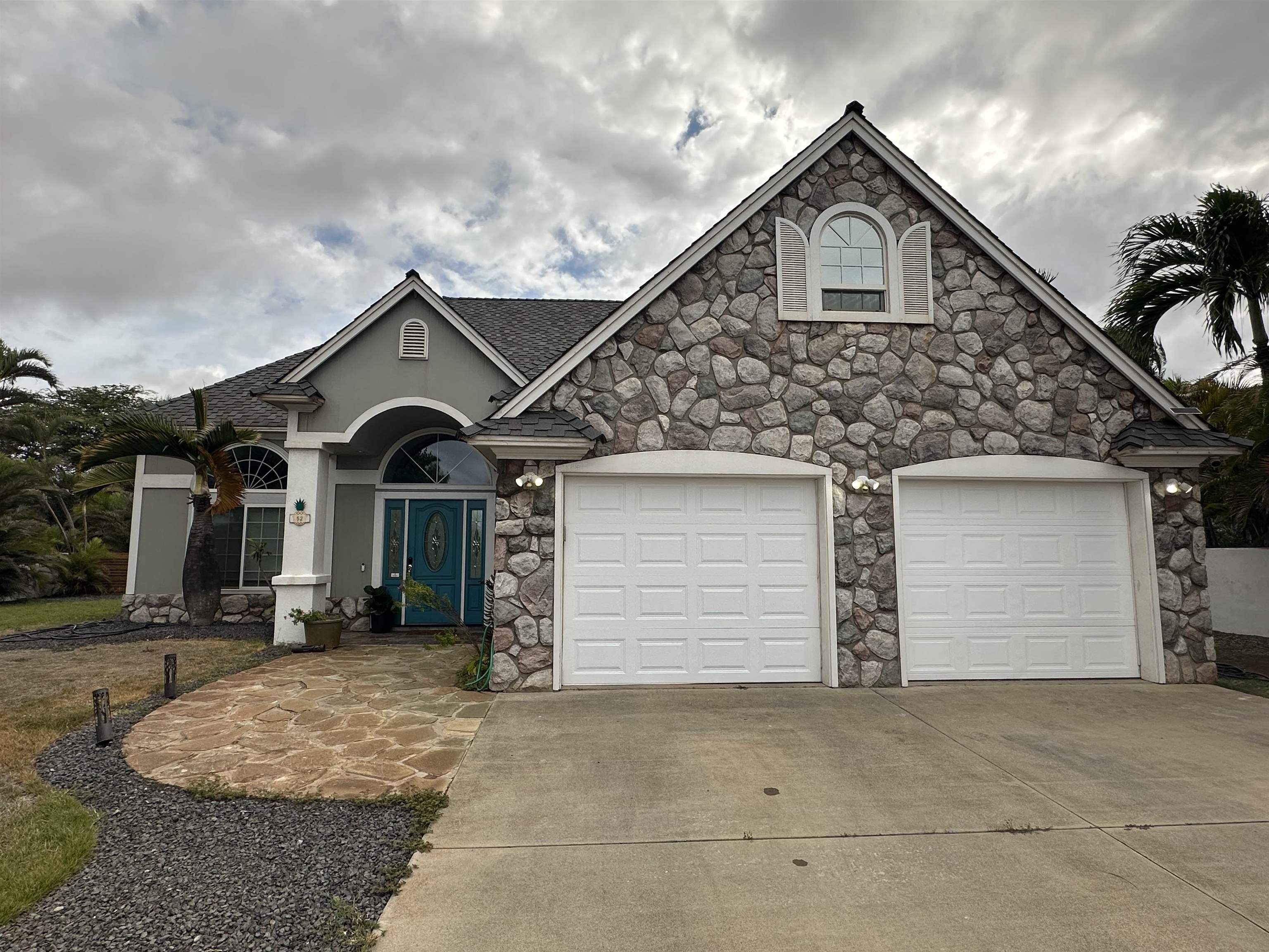 52 Kuukama Street Kahului, HI 96732 - Photo 1 of 28 a front view of a house with a yard and garage